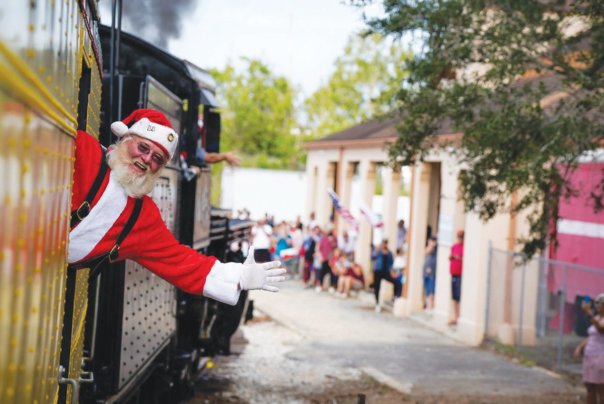 Santa waves during his route delivering Toys for Tots on the Santa Express Dec. 2